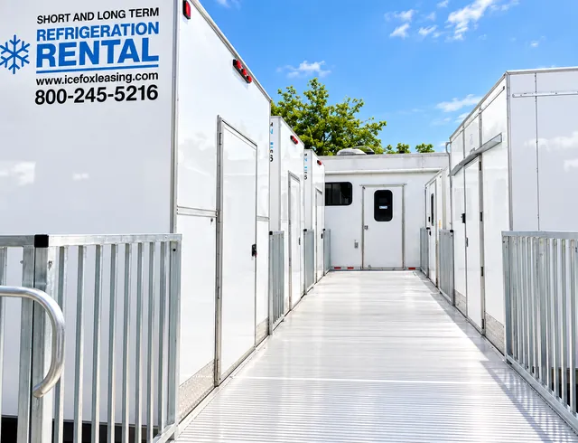 Refrigerated trailer fleet parked alongside a walkway