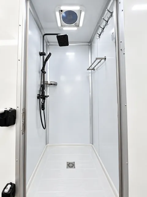 Private shower stall with handheld showerhead
