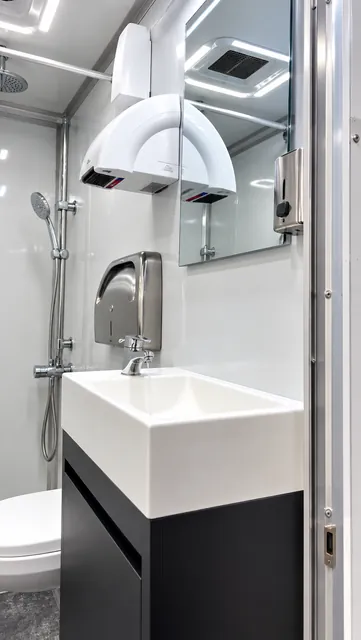 Private bathroom vanity, toilet, and shower