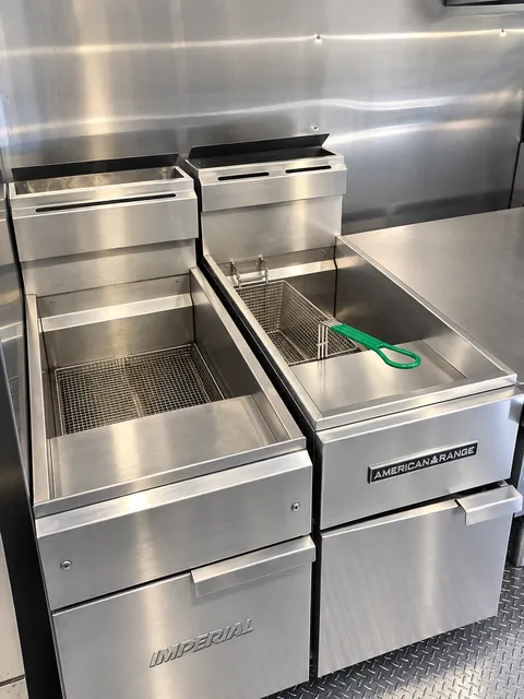 Cooking equipment beside stainless wall panels