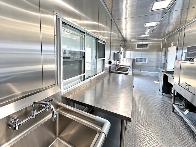 Stainless prep and wash stations along the aisle