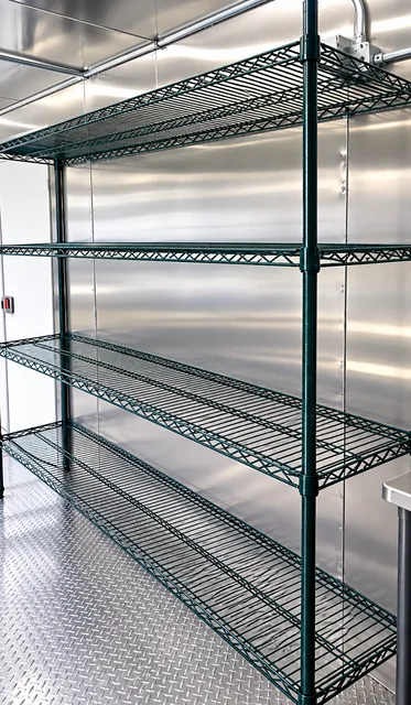 Open storage shelving inside a dishwashing trailer