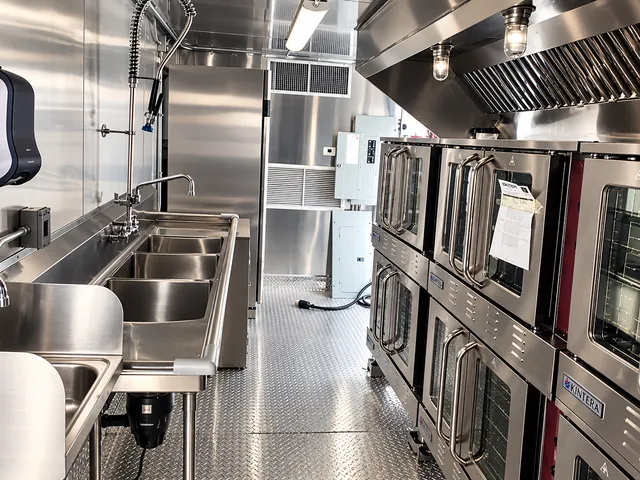 Kitchen interior with wash sinks and stacked ovens