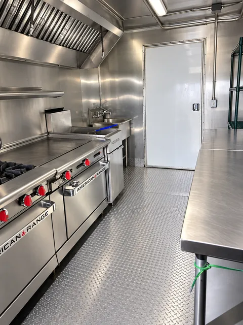 Commercial range and griddle beside a work table