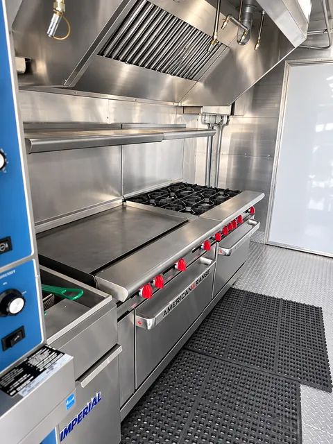 Range and griddle beneath an exhaust hood