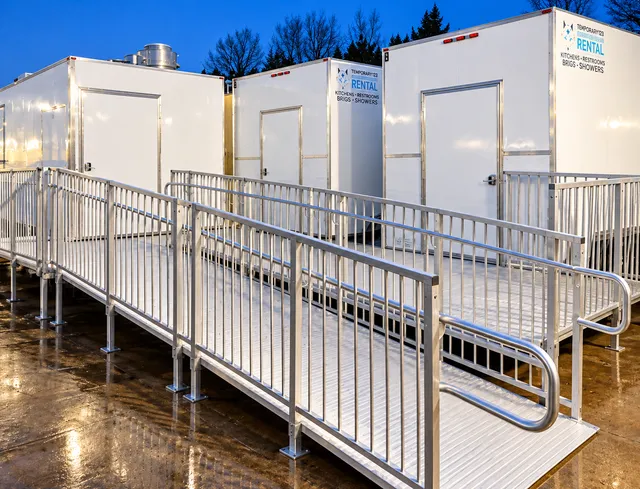 Metal ramps and railings alongside temporary units