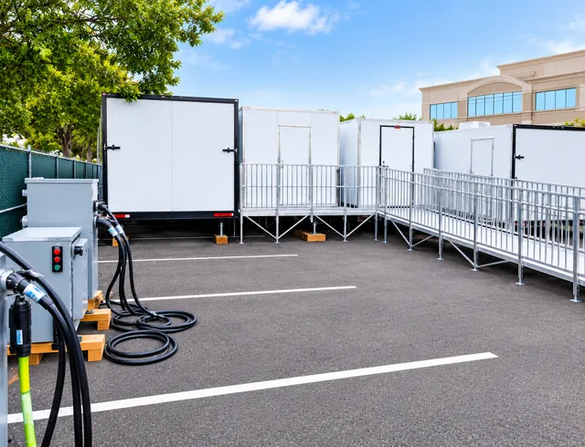 Trailer access ramp and handrails at a paved site