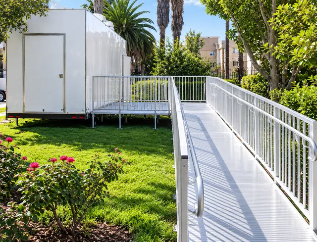 Access ramp and railings across a landscaped site