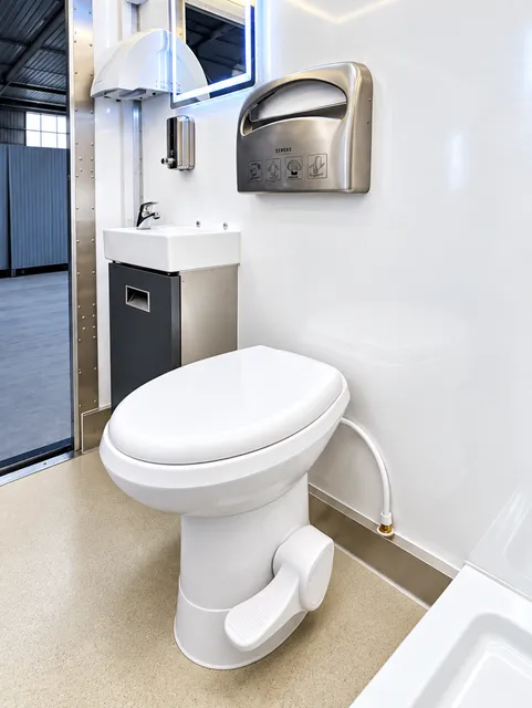 Restroom toilet beside the vanity