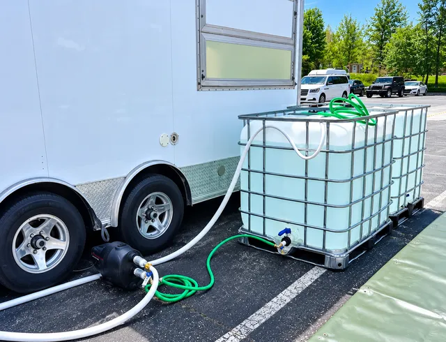Portable water tanks with connected hoses