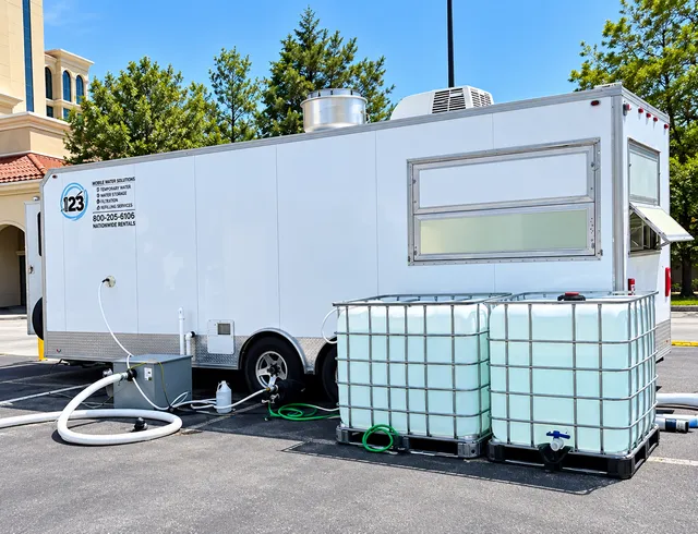 Temporary trailer with adjacent water storage tanks